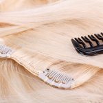Hair extensions clips and black brush, closeup